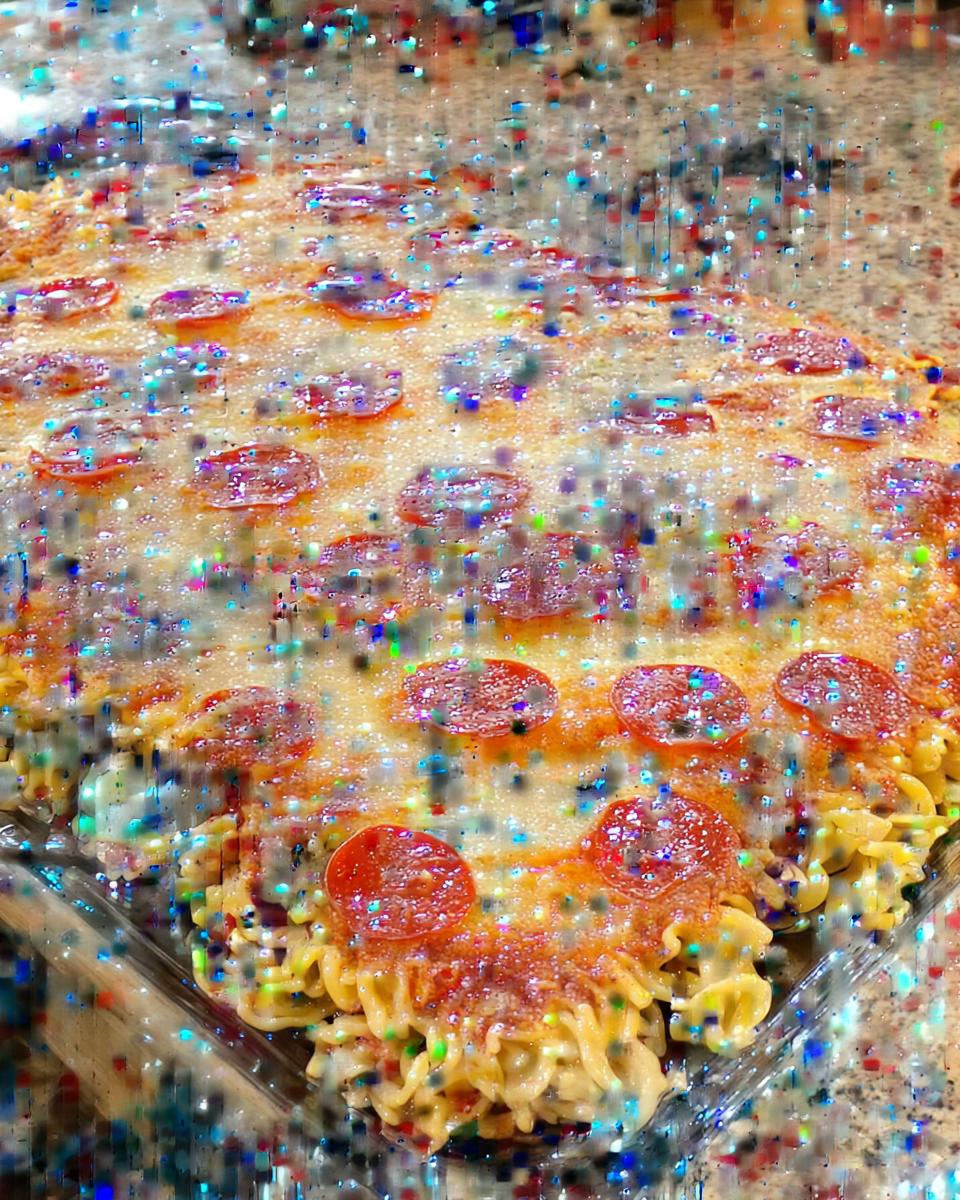 Close-up of a baked pizza pasta dish topped with melted cheese and pepperoni slices.