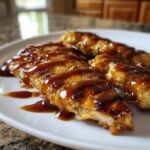 Close-up of grilled, sliced chicken breast generously coated in glossy homemade teriyaki sauce.